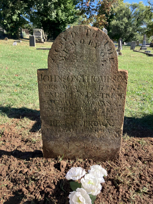 Detailed photograph of a historic granite tombstone in Potosi Presbyterian Cemetery, inscribed for Johnson Thompson, born August 3, 1799, died February 24, 1839, in Potosi, Missouri, noting a funeral sermon by Rev. E. C. Brown from Revelation 14:13: "Blessed are the dead which die in ." The marker, recently cleaned and reset, stands among other graves near Moses Austin's plot, linking to the Cherokee Trail of Tears northern route tragedies.